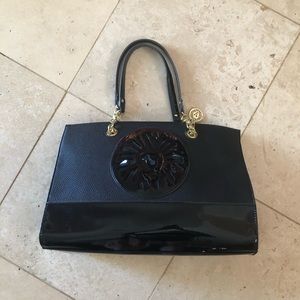 Black large purse with lion, will fit a laptop.